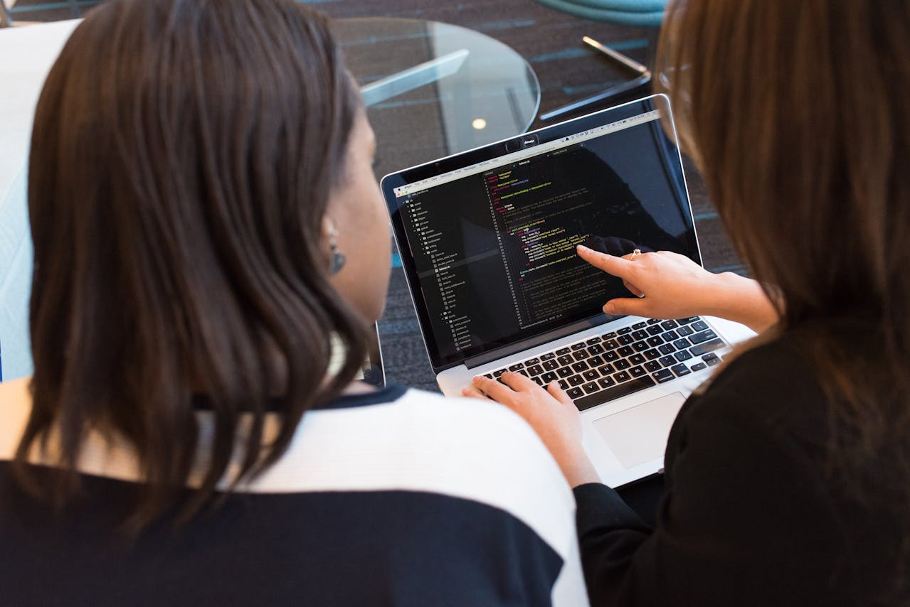 woman sitting at computer looking at code